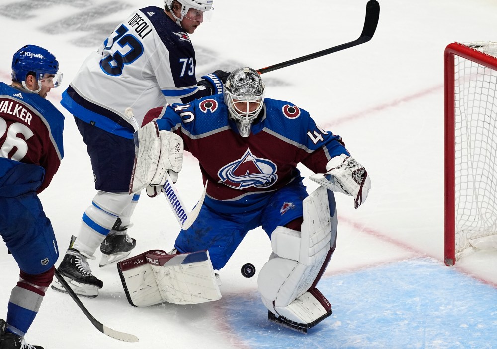Colorado Avalanche goaltender Alexandar Georgiev clears the puck as Winnipeg Jets Tyler Toffoli looks on in the third period. (David Zalubowski / The Associated Press)