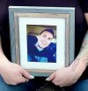 Tanya Hornbuckle holds a photo of her son Joel Wolstenholme, who fatally overdosed at his home in Edmonton on Feb. 6, 2022. THE CANADIAN PRESS/HO