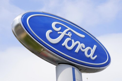 FILE - A Ford sign is shown at a dealership in Springfield, Pa., Tuesday, April 26, 2022. Ford is recalling nearly 243,000 Maverick small pickup trucks in the U.S. because the tail lights may not illuminate. The company says a computer can falsely detect too much current on one or both of the lights, causing them to stay dark while the trucks are moving. (AP Photo/Matt Rourke)