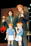 FILE - Argentina's soccer star Diego Maradona, left, and West German goalkeeper Harald Schumacher are holding their World Cup Soccer Ball awards while posing with two young soccer players during the Soccer Golden Shoe Award ceremony held in Paris, France, on Nov. 13, 1986. A trophy won by the late Diego Maradona for the best player at the 1986 World Cup that had mysterioulsy disappeared has resurfaced. It will be auctioned in Paris next month, the Aguttes house said on Tuesday May 7, 2024. (AP Photo/Michael Lipchitz, File)