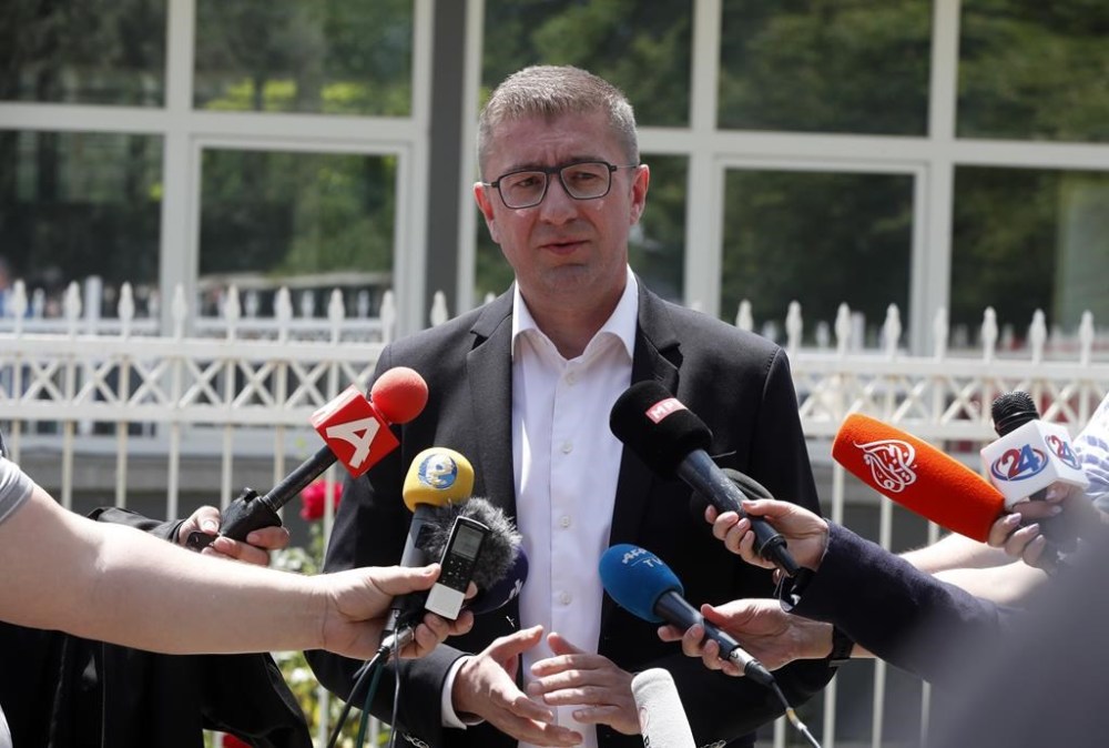 Hristijan Mickoski, the leader of the opposition center-right VMRO-DPMNE party, makes statements at a polling station in Skopje, North Macedonia, on Wednesday, May 8, 2024. Voters in North Macedonia were casting ballots on Wednesday in a parliamentary election and a presidential runoff dominated by issues including the country's path toward European Union membership, corruption and the economy. (AP Photo/Boris Grdanoski)