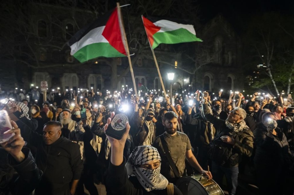 Protesters chant outside of a pro-Palestinian encampment set up on the University of Toronto campus in Toronto on Thursday, May 2, 2024. Organizers of a pro-Palestinian protest encampment at the University of Toronto say the university is ignoring their demands and instead focusing on the logistics of the demonstration. THE CANADIAN PRESS/Christopher Katsarov