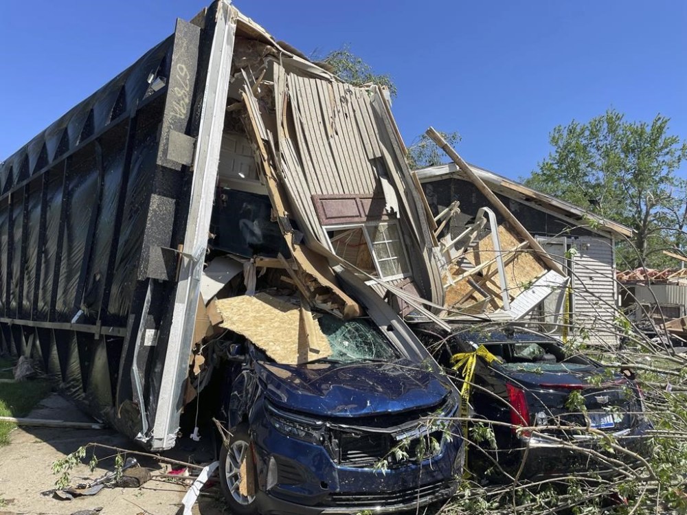 A mobile park home flipped onto two nearby cars after a tornado struck Pavilion Estates near Kalamazoo, Mich. on Wednesday, May 8, 2024. (AP Photo/Joey Cappelletti)