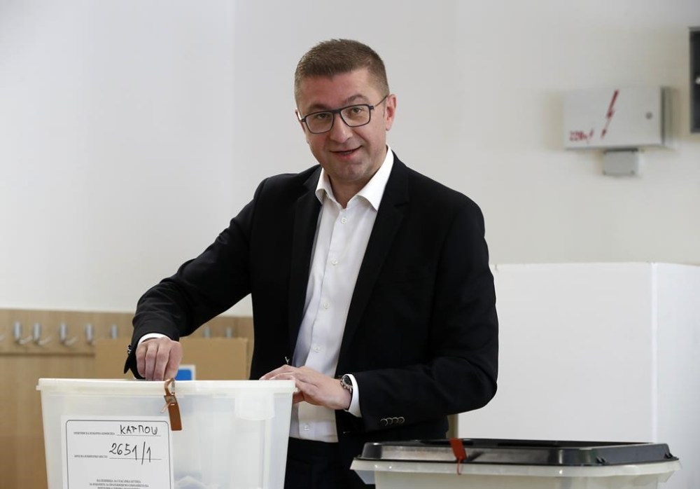 Hristijan Mickoski, the leader of the opposition center-right VMRO-DPMNE party, casts his ballots at a polling station in Skopje, North Macedonia, on Wednesday, May 8, 2024. Voters in North Macedonia were casting ballots on Wednesday in a parliamentary election and a presidential runoff dominated by issues including the country's path toward European Union membership, corruption and the economy. (AP Photo/Boris Grdanoski)