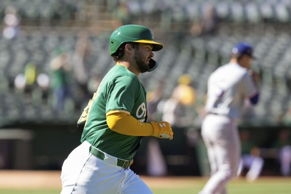 Oakland Athletics' Shea Langeliers runs the bases after hitting a two-run home run off Texas Rangers pitcher Jack Leiter, background, during the second inning in the second baseball game of a doubleheader Wednesday, May 8, 2024, in Oakland, Calif. (AP Photo/Godofredo A. Vásquez)
