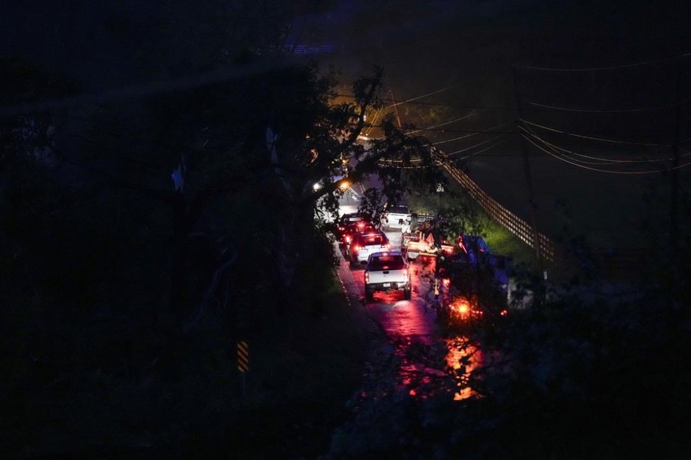 Emergency crews are seen along Cranford Hollow Road after severe storms tore through the area Wednesday, May 8, 2024, in Columbia, Tenn. (AP Photo/George Walker IV)