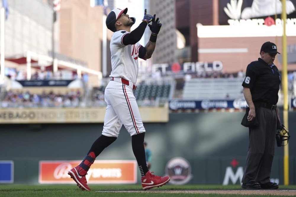Minnesota Twins' Carlos Correa gestures while crossing home plate after hitting a solo home run during the first inning of a baseball game against the Seattle Mariners, Wednesday, May 8, 2024, in Minneapolis. (AP Photo/Abbie Parr)