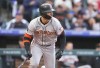 San Francisco Giants' Michael Conforto breaks from the batter's box after singling off Colorado Rockies starting pitcher Peter Lambert during the second inning of a baseball game Wednesday, May 8, 2024, in Denver. (AP Photo/David Zalubowski)