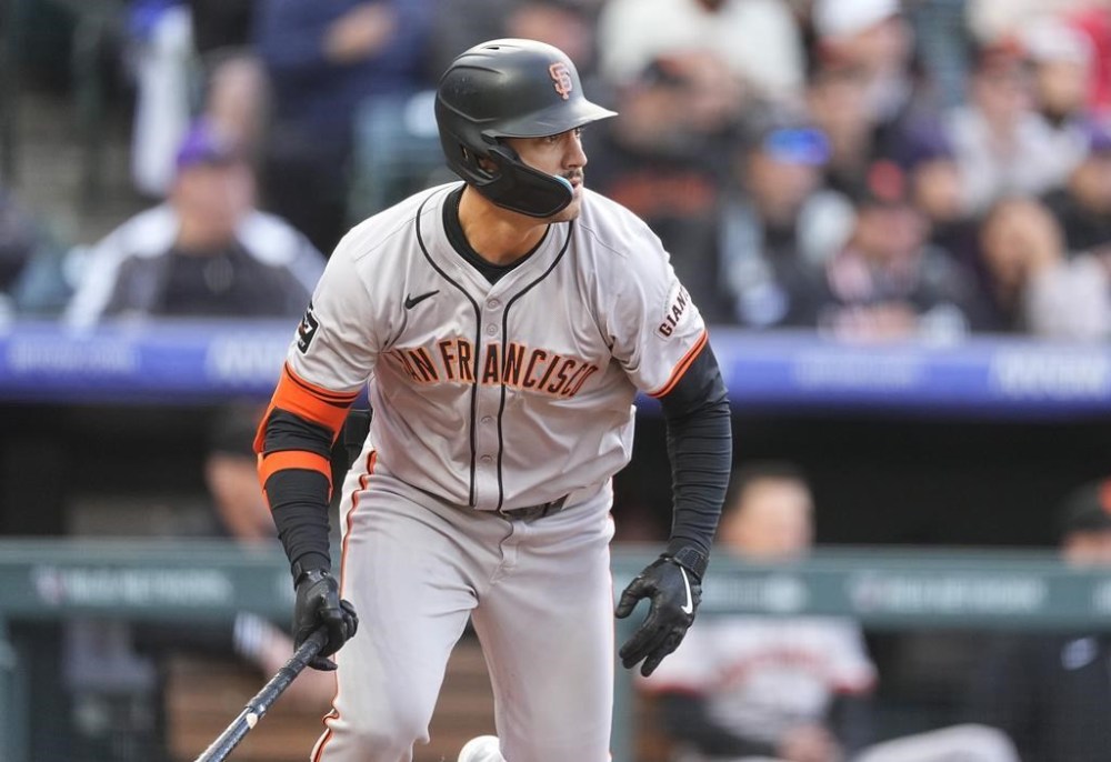 San Francisco Giants' Michael Conforto breaks from the batter's box after singling off Colorado Rockies starting pitcher Peter Lambert during the second inning of a baseball game Wednesday, May 8, 2024, in Denver. (AP Photo/David Zalubowski)