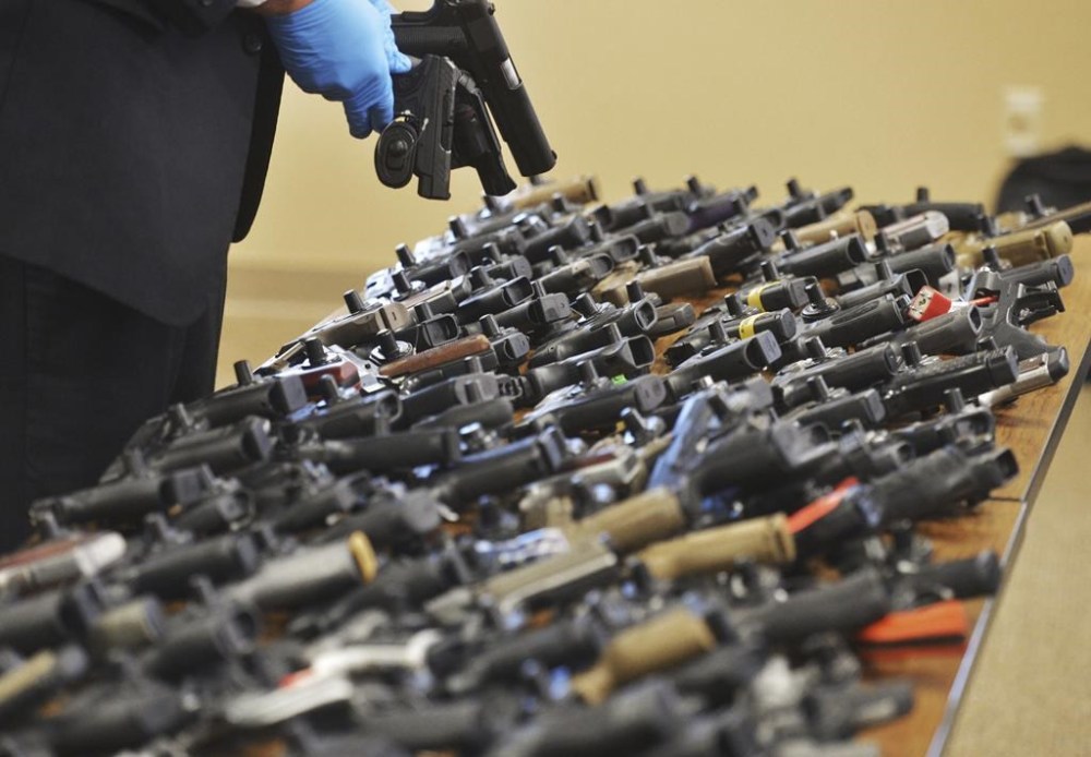 FILE - Dozens of recovered stolen handguns are displayed during a press conference, Nov. 21, 2023, in Benton Township, Mich. Two men, who are brothers, are accused of targeting a Dunham's near Benton Harbor. The rate of guns stolen from cars in the U.S. has tripled over the last decade, making them the largest source of stolen guns in the country, a new analysis of FBI data by the gun-safety group Everytown found. (Don Campbell/The Herald-Palladium via AP, File)