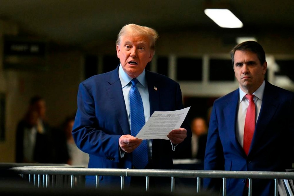Former President Donald Trump speaks to reporters next to lawyer Todd Blanche at Manhattan Criminal Court in New York, Thursday, May 9, 2024. (Angela Weiss/Pool Photo via AP)