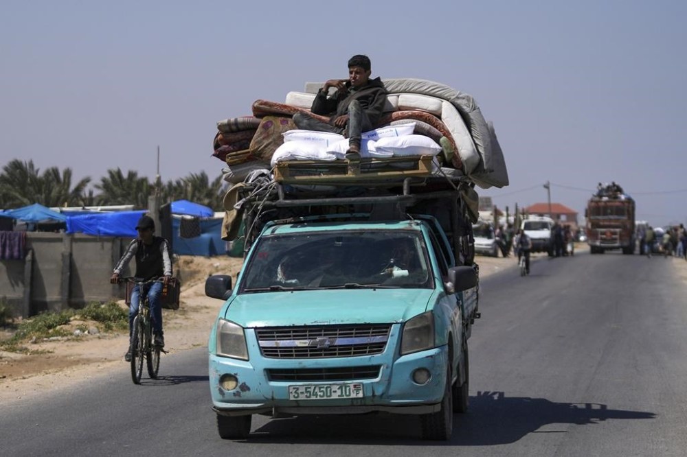 Displaced Palestinians arrive in central Gaza after fleeing from the southern Gaza city of Rafah in Deir al Balah, Gaza Strip, on Thursday, May 9, 2024. The Israeli army has ordered tens of thousands of people to evacuate Rafah as it conducts a ground operation there. (AP Photo/Abdel Kareem Hana)