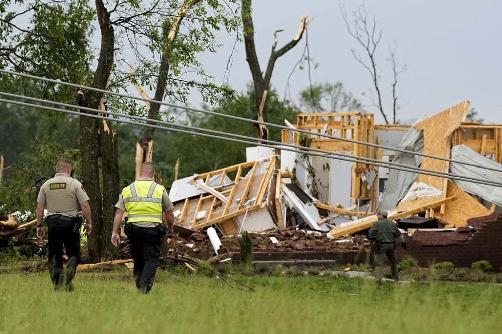 Maury County Sheriffs Deputies search through a storm damaged home along Blackburn Lane, Thursday, May 9, 2024, in Columbia, Tenn. Severe storms tore through the central and southeast U.S., Wednesday, spawning damaging tornadoes, producing massive hail, and killing two people in Tennessee. (AP Photo/George Walker IV)