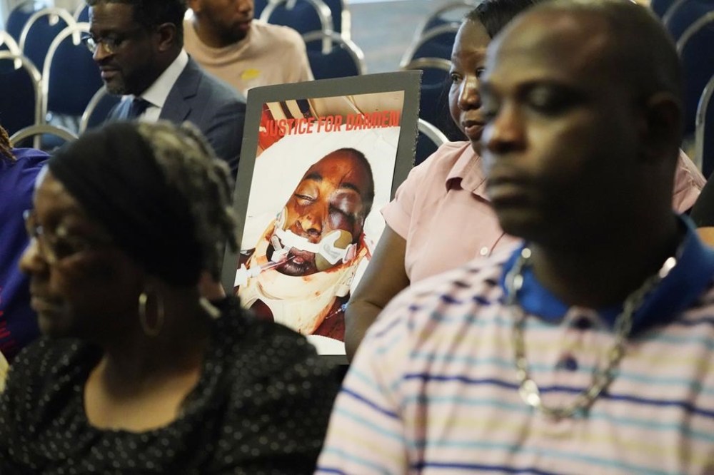 FILE - The families of Michael Corey Jenkins and Damien Cameron sit together prior to interacting with U.S. Assistant Attorney General Kristen Clarke of the Justice Department's Civil Rights Division, unseen, during the Jackson, Miss., stop on the division's civil rights tour, June 1, 2023. Six former Mississippi law officers, including some who call themselves the