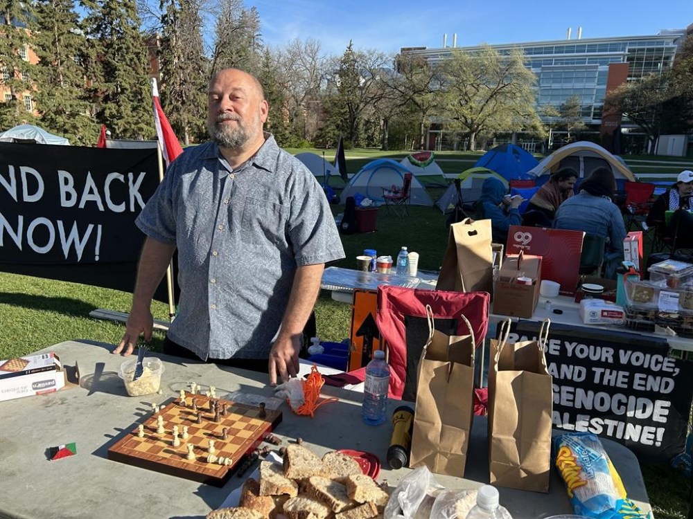 Political science professor David Kahane, a Gaza protest organizers, looks on at an encampment set up on the campus of the University of Alberta in Edmonton on Friday, May 10, 2024. THE CANADIAN PRESS/Dean Bennett