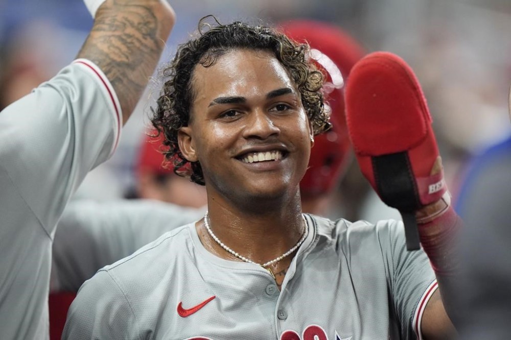 Philadelphia Phillies' Cristian Pache is congratulated by teammates after he and Edmundo Sosa scored on a single by Kyle Schwarber during the fourth inning of a baseball game against the Miami Marlins, Friday, May 10, 2024, in Miami. (AP Photo/Wilfredo Lee)