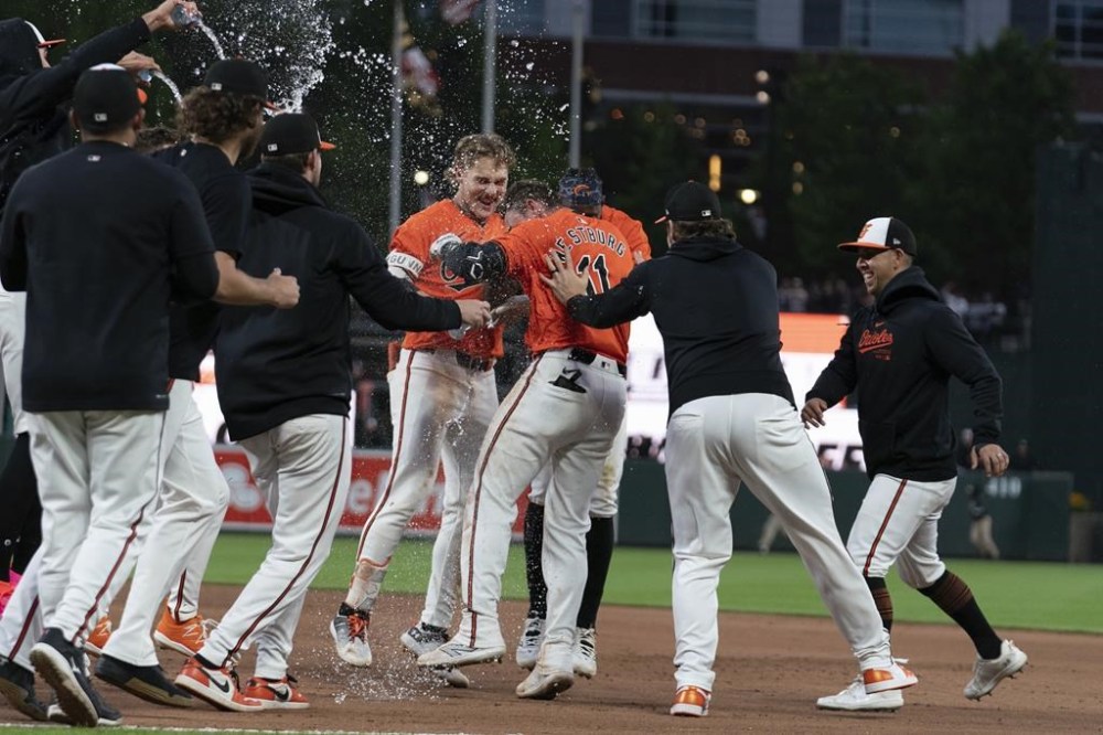 Baltimore Orioles' Jordan Westburg (11) celebrates with teammates after hitting a single to win a baseball game against the Arizona Diamondbacks in the 11th inning Saturday, May 11, 2024, in Baltimore. (AP Photo/Jose Luis Magana)