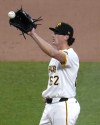 Pittsburgh Pirates relief pitcher Kyle Nicolas gets the ball back from catcher Yasmani Grandal after walking Chicago Cubs' Miles Mastrobuoni, forcing in a run, during the fifth inning of a baseball game in Pittsburgh, Saturday, May 11, 2024. (AP Photo/Gene J. Puskar)