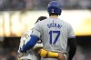 Los Angeles Dodgers' Shohei Ohtani, right, embraces San Diego Padres first baseman Luis Arraez after walking during the sixth inning of a baseball game, Saturday, May 11, 2024, in San Diego. (AP Photo/Gregory Bull)