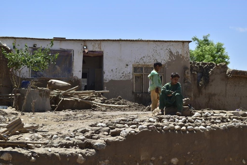 A boy sits near a damaged house after heavy flooding in Baghlan province, in northern Afghanistan, Sunday, May 12, 2024. Victims of the devastating floods in northern Afghanistan are burying the dead and looking for the loved ones still missing. (AP Photo)