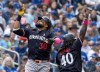 Minnesota Twins Carlos Santana (30) is congratulated by third base coach Tommy Watkins (40) after hitting a three run home off Toronto Blue Jays starter Alek Manoah during seventh inning MLB baseball action in Toronto, Sunday, May 12, 2024. THE CANADIAN PRESS/Frank Gunn