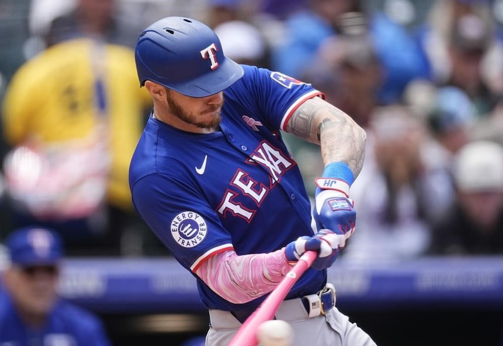 Texas Rangers' Jonah Heim grounds out against Colorado Rockies starting pitcher Ty Blach in the fourth inning of a baseball game Sunday, May 12, 2024, in Denver. (AP Photo/David Zalubowski)