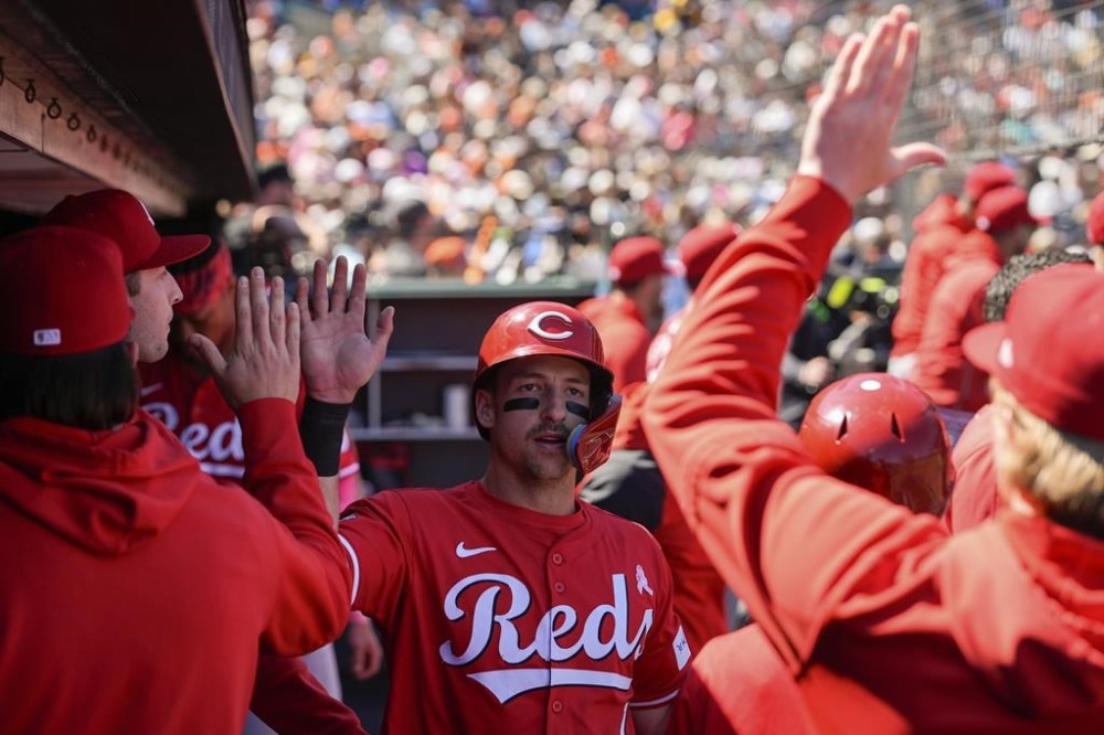 Cincinnati Reds' Spencer Steer, center, celebrates with teammates in the dugout after scoring against the San Francisco Giants on Jake Fraley's single during the seventh inning of a baseball game Sunday, May 12, 2024, in San Francisco. (AP Photo/Godofredo A. Vásquez)