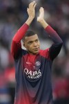 PSG's Kylian Mbappe greets supporters before the French League One soccer match between Paris Saint-Germain and Toulouse at the Parc des Princes stadium in Paris, Sunday, May 12, 2024. (AP Photo/Christophe Ena)