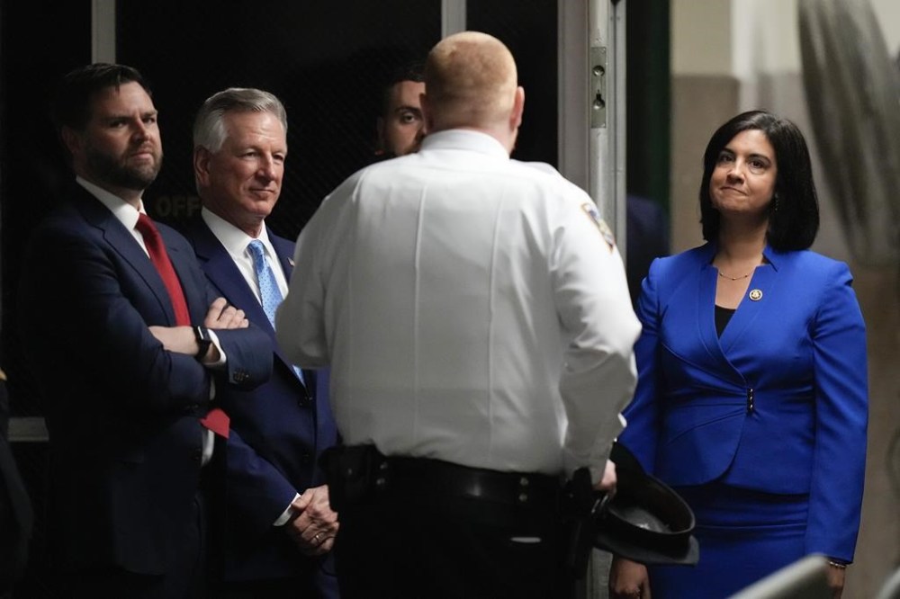 Sen. J.D. Vance, R-Ohio, left, Sen. Tommy Tuberville, R-Ala., second from left, and Rep. Nicole Malliotakis, R-N.Y.,right, wait in the hallway outside the courtroom for the arrival of former President Donald Trump at Manhattan criminal court, Monday, May 13, 2024, in New York. (AP Photo/Seth Wenig, Pool)