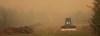 Fire crews battling a blaze outside Fort McMurray are expecting a little help from the weather today while crews working a wildfire, designated GCU007 by the Alberta Wildfire Service, near Grande Prairie say they expect unfavourable winds and no rain. An operator drives a bulldozer beside ditches dug to create a perimeter for a forest fire in an undated handout photo. THE CANADIAN PRESS/HO-Alberta Wildfire Service, *MANDATORY CREDIT*