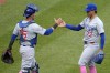 Chicago Cubs relief pitcher Adbert Alzolay (73) celebrates with catcher Yan Gomes, left, after getting the final out in the 10th inning to preserve a win over the Pittsburgh Pirates in a baseball game in Pittsburgh, Sunday, May 12, 2024. (AP Photo/Gene J. Puskar)
