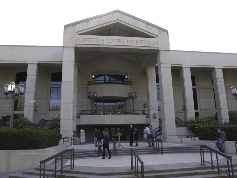 FILE - People gather outside the Nevada Supreme Court in Carson City, May 8, 2018. The Nevada Supreme Court, Monday, May 13, 2024, struck down a proposed ballot initiative that would allow voters to decide whether to repeal the public funding that lawmakers approved last year for a new MLB stadium in Las Vegas. (AP Photo/By Scott Sonner, File)