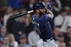 Tampa Bay Rays' Amed Rosario watches the flight of his RBI double during the eighth inning of a baseball game against the Boston Red Sox, Monday, May 13, 2024, in Boston. (AP Photo/Charles Krupa, Pool)