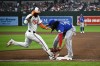 Baltimore Orioles' Cedric Mullins, left, is out at first against Toronto Blue Jays first baseman Vladimir Guerrero Jr., right, during the fifth inning of a baseball game, Monday, May 13, 2024, in Baltimore. (AP Photo/Nick Wass)