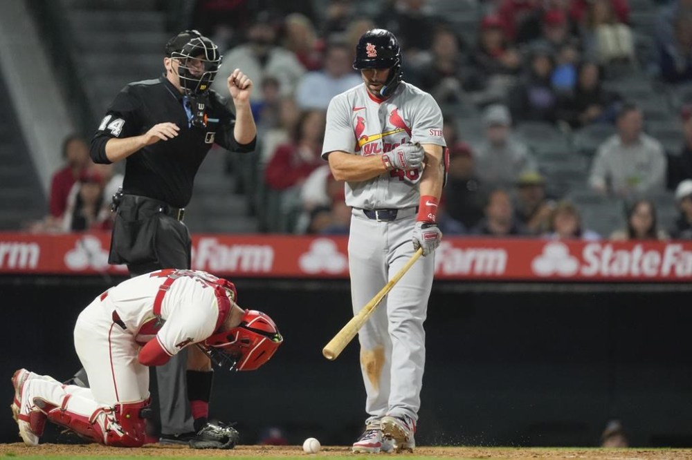 Los Angeles Angels catcher Logan O'Hoppe, bottom left, reacts after being hit by a pitch that also hit St. Louis Cardinals' Paul Goldschmidt, right, during the seventh inning of a baseball game, Monday, May 13, 2024, in Anaheim, Calif. (AP Photo/Ryan Sun)