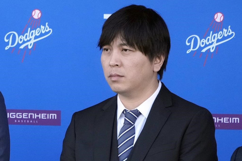FILE - Interpreter Ippei Mizuhara listens during a baseball news conference at Dodger Stadium, Thursday, Dec. 14, 2023, in Los Angeles. Mizuhara, the former interpreter for Los Angeles Dodgers star Shohei Ohtani, is expected to plead not guilty Tuesday, May 14, 2024, to bank and tax fraud, a formality ahead of a deal he has negotiated with federal prosecutors in a sports betting case. (AP Photo/Marcio Jose Sanchez, File)