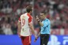 Referee Clement Turpin, right, speaks with Bayern's Harry Kane during the Champions League semifinal first leg soccer match between Bayern Munich and Real Madrid at the Allianz Arena in Munich, Germany, Tuesday, April 30, 2024. (AP Photo/Matthias Schrader)