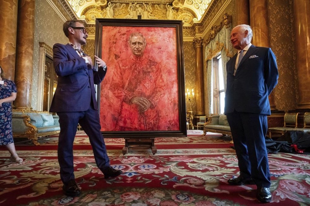 Artist Jonathan Yeo, left, and Britain's King Charles III at the unveiling of artist Yeo's portrait of the King, in the blue drawing room at Buckingham Palace, in London, May 14. (Aaron Chown / Pool Photo via The Associated Press)