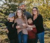 Nine-year-old Carter Vigh, wearing a red sweatshirt, is pictured with his brother Daxton (left), sister Cadence, father James and mother Amber. Carter died of asthma exacerbated by wildfire smoke in July 2023. As wildfires rage in B.C., his family is trying to protect people from poor air quality due to smoke this year. THE CANADIAN PRESS/HO-Vigh Family **MANDATORY CREDIT**