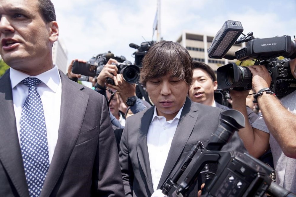 Ippei Mizuhara, center, the former longtime interpreter for the Los Angeles Dodgers baseball star Shohei Ohtani, leaves federal court following his arraignment, Tuesday, May 14, 2024, in Los Angeles. Mizuhara pleaded not guilty Tuesday to bank and tax fraud, a formality ahead of a plea deal he’s negotiated with federal prosecutors in a wide-ranging sports betting case. (AP Photo/Eric Thayer)