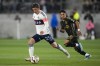 Vancouver Whitecaps midfielder Ryan Gauld (25) controls the ball ahead of Los Angeles FC defender Erik Dueñas (18) during the second half of an MLS soccer match in Los Angeles on May 11, 2024. THE CANADIAN PRESS/AP, Ashley Landis