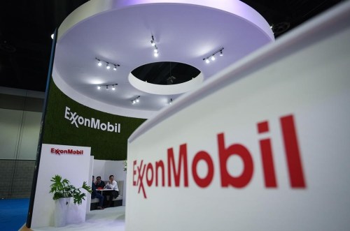 Delegates meet at the Exxon Mobil booth during the LNG2023 conference, in Vancouver on July 11, 2023. THE CANADIAN PRESS/Darryl Dyck
