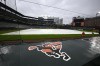 The tarp covers the field as the baseball game between the Baltimore Orioles and the Toronto Blue Jays was postponed due to weather, Tuesday, May 14, 2024, in Baltimore. The game will be made up as part of a traditional doubleheader on Monday, July 29. (AP Photo/Nick Wass)