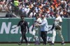 San Francisco Giants center fielder Jung Hoo Lee, second from left, is helped off the field following an injury during the first inning of a baseball game against the Cincinnati Reds, Sunday, May 12, 2024, in San Francisco. (AP Photo/Godofredo A. Vásquez)
