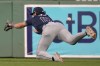 Tampa Bay Rays outfielder Josh Lowe dives but can't make the play on a two-RBI double by Boston Red Sox's Dominic Smith during the fourth inning of a baseball game at Fenway Park, Tuesday, May 14, 2024, in Boston. (AP Photo/Charles Krupa)