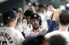 Houston Astros' Alex Bregman celebrates with teammates in the dugout after hitting a home run against the Oakland Athletics during the second inning of a baseball game Tuesday, May 14, 2024, in Houston. (AP Photo/David J. Phillip)