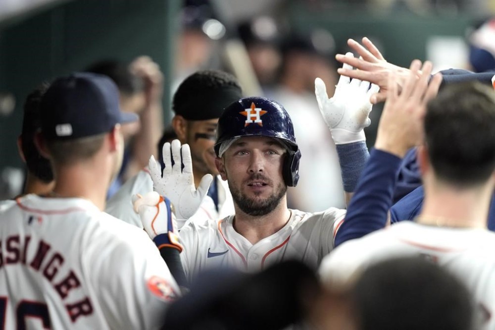 Houston Astros' Alex Bregman celebrates with teammates in the dugout after hitting a home run against the Oakland Athletics during the second inning of a baseball game Tuesday, May 14, 2024, in Houston. (AP Photo/David J. Phillip)