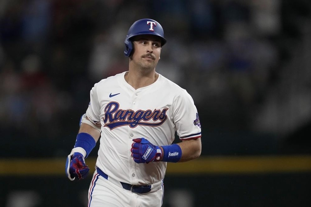 Texas Rangers' Nathaniel Lowe rounds the bases after hitting a solo home run against the Cleveland Guardians in the fifth inning of a baseball game, Tuesday, May 14, 2024, in Arlington, Texas. (AP Photo/Tony Gutierrez)