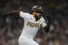 San Diego Padres' Fernando Tatis Jr. runs to first base after hitting a single during the seventh inning of a baseball game against the Colorado Rockies, Tuesday, May 14, 2024, in San Diego. (AP Photo/Gregory Bull)