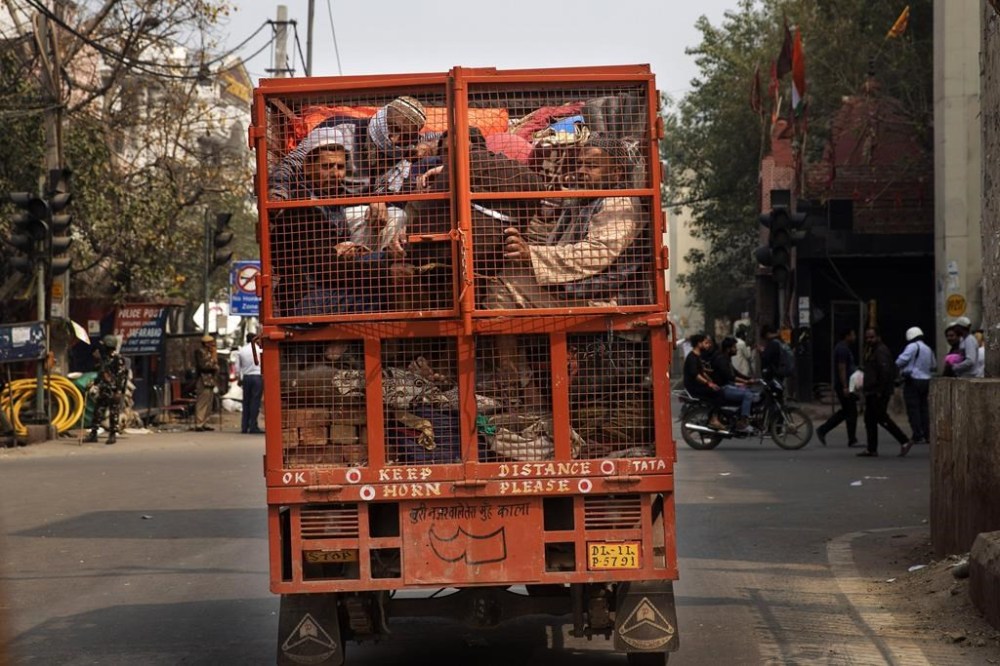 FILE - A group of Muslims huddle together in the back of a mini truck after violent clashes in the locality in New Delhi, India, on Feb. 26, 2020. Tensions between Hindus and Muslims in India are not new, but they have gotten worse under Prime Minister Narendra Modi. (AP Photo/Rajesh Kumar Singh, File)